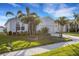 Beautiful home with a two-car garage and lush front yard featuring meticulously trimmed palm trees at 6211 114Th E Dr, Parrish, FL 34219