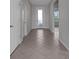 This light and bright hallway features a neutral color palette and ceramic tile floors at 6211 114Th E Dr, Parrish, FL 34219
