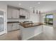 Kitchen island features granite countertops, stainless steel appliances, and bright, neutral finishes at 6211 114Th E Dr, Parrish, FL 34219