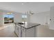 Kitchen island offers ample counter space and seamless flow to adjacent living areas and backyard at 6211 114Th E Dr, Parrish, FL 34219