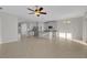 Spacious open-concept living area with tile floors, ceiling fan, and abundant natural light at 6211 114Th E Dr, Parrish, FL 34219