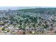 Wide aerial shot shows a neighborhood with many single-Gathering homes, lush trees, and a body of water in the distance at 6304 Memorial Hwy, Tampa, FL 33615