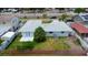 Aerial view of property with a patio, green lawn, and mature palm tree at 6304 Memorial Hwy, Tampa, FL 33615
