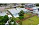 Aerial view showcasing the home's layout, with patio, and palm trees in the yard at 6304 Memorial Hwy, Tampa, FL 33615