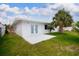 Charming backyard features a patio, lush lawn, and mature palm tree at 6304 Memorial Hwy, Tampa, FL 33615