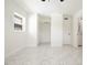 Spacious bedroom with a ceiling fan, marble floors, closet, and en-suite bathroom at 6304 Memorial Hwy, Tampa, FL 33615