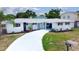 Charming single-story home featuring a white brick facade and well-maintained landscaping at 6304 Memorial Hwy, Tampa, FL 33615