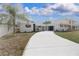 A well maintained white brick home featuring professional landscaping and a bright driveway at 6304 Memorial Hwy, Tampa, FL 33615