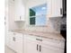 Well-lit kitchen showcasing custom cabinetry, a stylish backsplash, and granite countertops at 6304 Memorial Hwy, Tampa, FL 33615