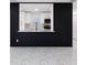 Modern kitchen pass-through with marble countertops, white cabinetry, and black accent wall at 6304 Memorial Hwy, Tampa, FL 33615