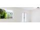 Bright living room featuring ample natural light, new flooring and double glass doors at 6304 Memorial Hwy, Tampa, FL 33615