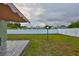 Expansive backyard with lush green grass, a privacy fence, and a deck area, ideal for outdoor activities at 6401 15Th N St, St Petersburg, FL 33702