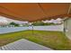 Private backyard featuring a partial deck, awning, and secure perimeter fence at 6401 15Th N St, St Petersburg, FL 33702