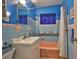 Bright bathroom featuring blue tile, and a bathtub at 6401 15Th N St, St Petersburg, FL 33702