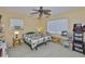 This cozy bedroom features neutral walls, a ceiling fan, and large windows that provide plenty of natural light at 6401 15Th N St, St Petersburg, FL 33702