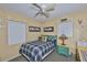 Comfortable bedroom with a ceiling fan, large windows, and stylish decor, perfect for a relaxing retreat at 6401 15Th N St, St Petersburg, FL 33702
