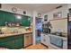 Functional kitchen boasts stainless steel appliances, practical cabinets, and tiled floor at 6401 15Th N St, St Petersburg, FL 33702