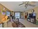 Spacious living room featuring comfortable seating, and a view of the backyard through sliding glass doors at 6401 15Th N St, St Petersburg, FL 33702