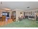 Inviting living room with green carpet, comfortable seating, and a decorative display cabinet at 6401 15Th N St, St Petersburg, FL 33702