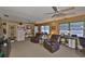 Comfortable living room featuring ceiling fans and large windows for ample natural light at 6401 15Th N St, St Petersburg, FL 33702