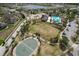 Aerial view of community with lake, clubhouse, pool, basketball court, and green space at 6512 Trent Creek Dr, Sun City Center, FL 33573