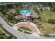 Aerial view of neighborhood pool, clubhouse, playground, and manicured landscaping at 6512 Trent Creek Dr, Sun City Center, FL 33573