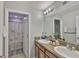 Bathroom features double sinks, granite counters, and a shower with patterned curtains at 6512 Trent Creek Dr, Sun City Center, FL 33573