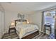 Bedroom featuring yellow floral bedding, dark wood floors, and modern wall decor at 6512 Trent Creek Dr, Sun City Center, FL 33573