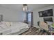 This bedroom features wood floors, a modern light fixture, and an organized desk area at 6512 Trent Creek Dr, Sun City Center, FL 33573
