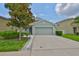 Charming single-Gathering home with a well-maintained lawn and a two-car garage at 6512 Trent Creek Dr, Sun City Center, FL 33573