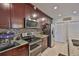 Modern kitchen with stainless appliances, granite countertops, and stylish backsplash at 6512 Trent Creek Dr, Sun City Center, FL 33573