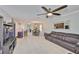Open-concept living room with tile flooring, ceiling fan, and comfortable leather seating at 6512 Trent Creek Dr, Sun City Center, FL 33573