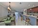 Open-concept living space with a dining area, modern lighting, and seamless flow to the kitchen at 6512 Trent Creek Dr, Sun City Center, FL 33573