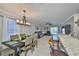 Open-concept living space with a dining area, modern lighting, and seamless flow to the living room at 6512 Trent Creek Dr, Sun City Center, FL 33573