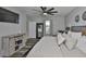 Serene primary bedroom featuring a ceiling fan, plush bedding and stylish decor at 6512 Trent Creek Dr, Sun City Center, FL 33573