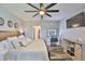 Comfortable main bedroom featuring a wooden bed frame and wood look floors at 6512 Trent Creek Dr, Sun City Center, FL 33573