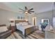 Comfortable main bedroom featuring a wooden bed frame and wood look floors at 6512 Trent Creek Dr, Sun City Center, FL 33573