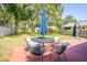 Backyard patio with table and chairs underneath mature shade trees at 7065 73Rd N St, Pinellas Park, FL 33781