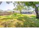 Spacious backyard featuring a wooden fence, patio with dining set, and mature landscaping at 7065 73Rd N St, Pinellas Park, FL 33781