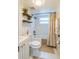 Well-lit bathroom with shower and shelves with plants at 7065 73Rd N St, Pinellas Park, FL 33781