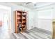 Bedroom featuring wood-look floors with bookshelf and mirrored wardrobe at 7065 73Rd N St, Pinellas Park, FL 33781