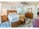 Bedroom with wood-look flooring and wood bedroom set and ceiling fan at 7065 73Rd N St, Pinellas Park, FL 33781