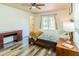 Bright bedroom featuring desk, natural light, and wood-look flooring at 7065 73Rd N St, Pinellas Park, FL 33781