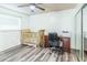 Bedroom featuring wood-look floors with crib and desk workspace at 7065 73Rd N St, Pinellas Park, FL 33781