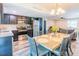 Charming dining area and kitchen featuring stainless steel appliances, dark wood cabinets, and stylish flooring for a modern touch at 7065 73Rd N St, Pinellas Park, FL 33781