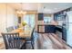 Cozy dining area and kitchen featuring stainless steel appliances, elegant cabinetry, and modern flooring, creating an inviting space at 7065 73Rd N St, Pinellas Park, FL 33781