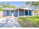 Charming single-story home with a covered parking area and blue exterior paint at 7065 73Rd N St, Pinellas Park, FL 33781