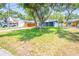 Single-story home with mature trees providing shade in the front yard at 7065 73Rd N St, Pinellas Park, FL 33781
