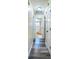 Hallway that looks into a remodeled bathroom with plank flooring at 7065 73Rd N St, Pinellas Park, FL 33781