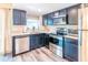 Stylish kitchen showcasing stainless steel appliances, dark wood cabinets, and sleek countertops for a modern, functional design at 7065 73Rd N St, Pinellas Park, FL 33781